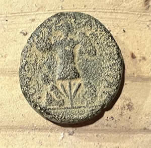 71-73 AD - Titus Judaea Capta minted in Caesarea obverse Titus, reverse female Jewish captive seated bound under trophy made of captured arms: helmet, cuirass, shields, spears